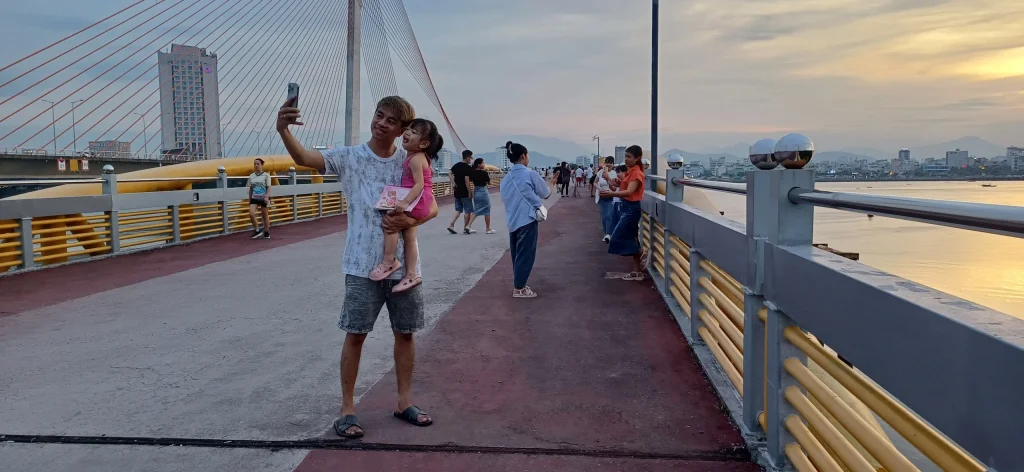 Visitors checking in at Nguyen Van Troi Bridge in Da Nang, capturing the vibrant atmosphere and scenic views of the surrounding area.