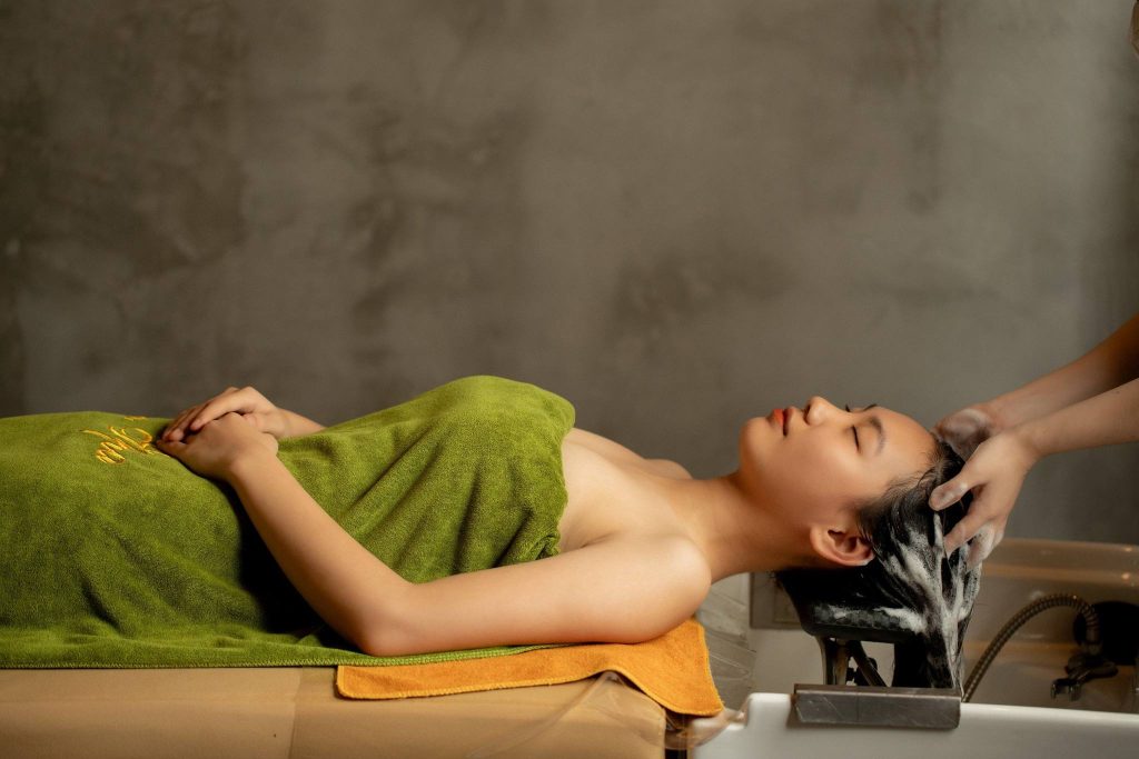Guest receiving herbal head wash at Nguon Spa