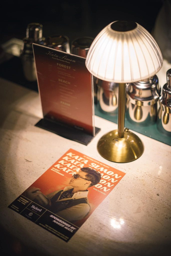 455343517 1012361457564783 2044502310494998558 n A lamp and a magazine are placed on a wooden table, creating a cozy reading atmosphere.