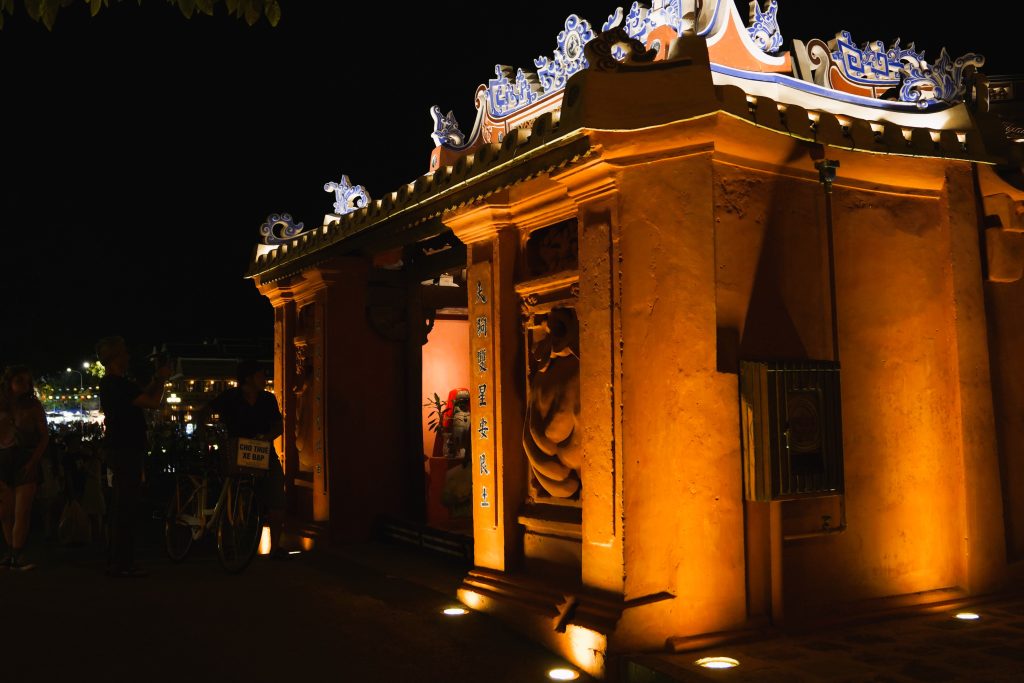 The Hoi An Japanese Bridge, also known as **Cau Pagoda**, is a historical and architectural treasure in **Hoi An Ancient Town**. Built in the early 17th century, it beautifully reflects a harmonious blend of Japanese, Chinese, and Vietnamese styles. Adorned with intricate wooden carvings and statues, this iconic landmark once connected two distinct cultural communities. It offers stunning photo opportunities, especially at sunrise and sunset, with its tranquil surroundings and vibrant lanterns illuminating the night, creating a timeless atmosphere for visitors.