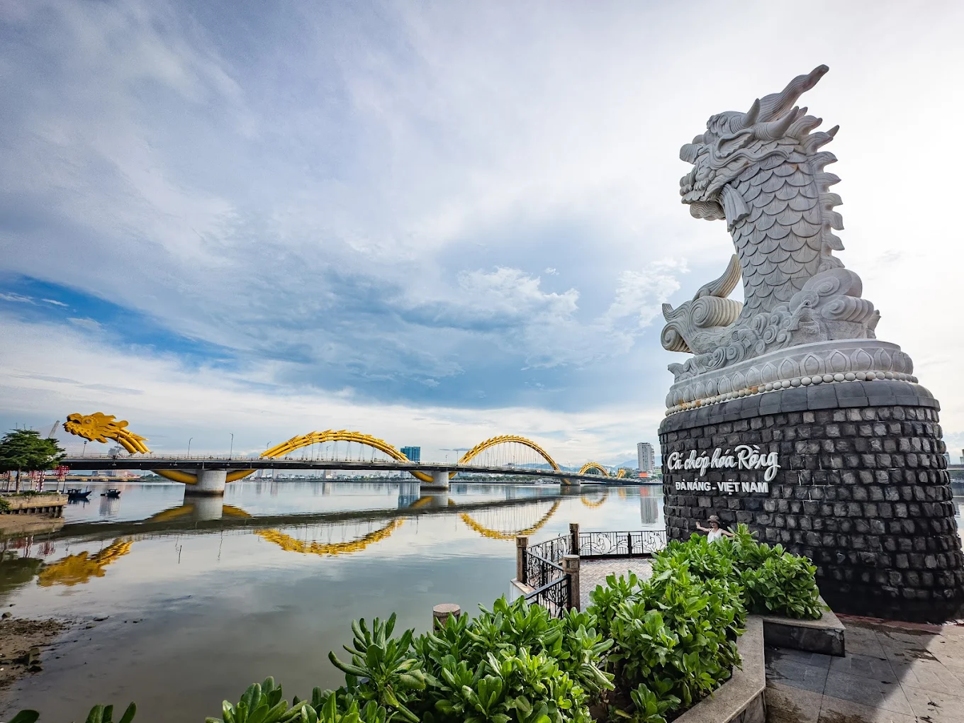 The Carp Dragon Statue in Da Nang is a striking sculpture symbolizing prosperity and power, inspired by the legend of the carp transforming into a dragon. Located along the Han River, this impressive marble statue features a majestic dragon's head and a carp's body. The sculpture, which stands over 7.5 meters tall, overlooks the river, with water spouting from the dragon’s mouth. It is beautifully illuminated at night, creating a popular photo spot and a symbol of Da Nang's blend of tradition and modernity.