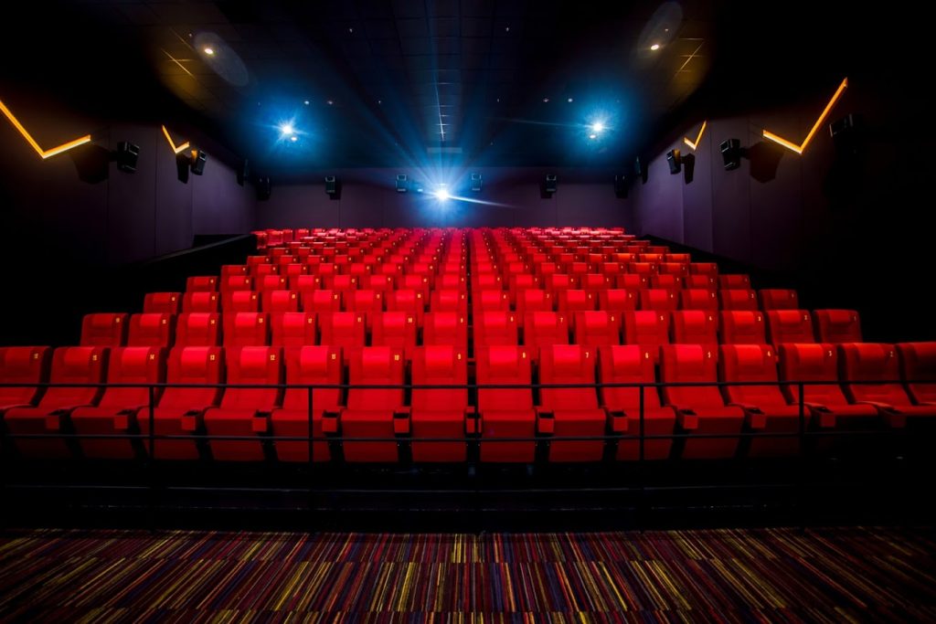 inside the movie theater with a bunch of red chair for movie theater.