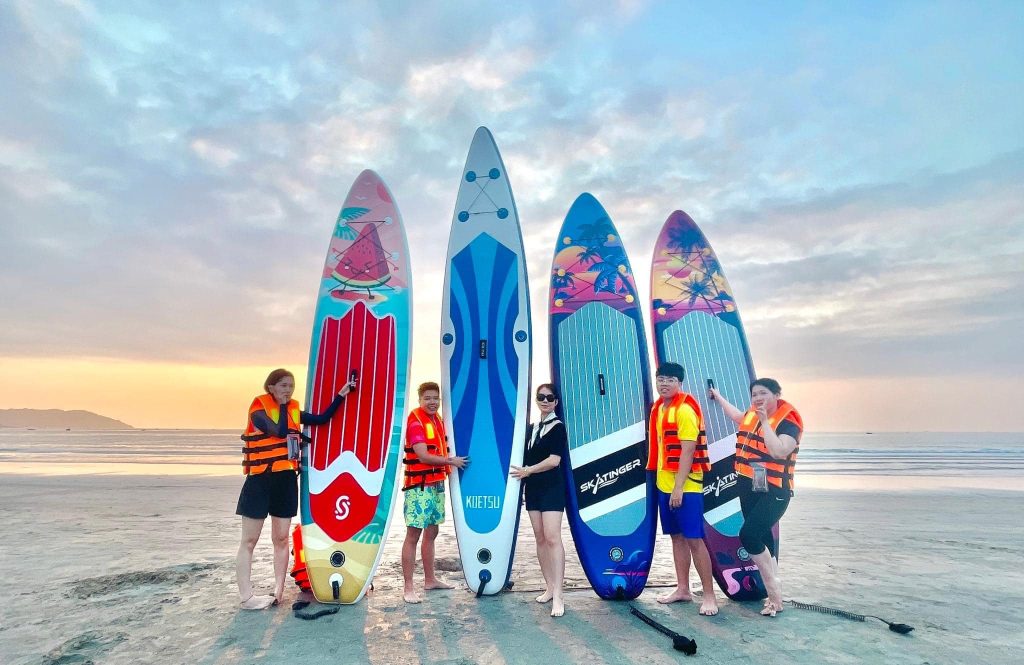 A group of friends paddleboarding, enjoying the summer atmosphere
