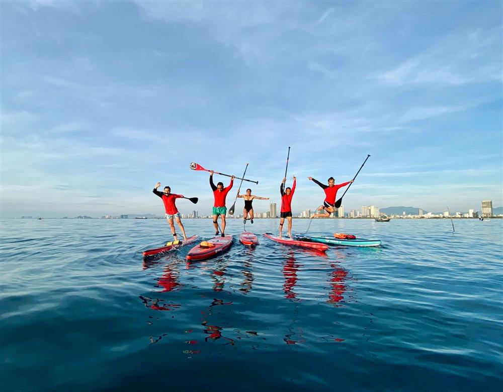 Group of friends posing on SUP board
