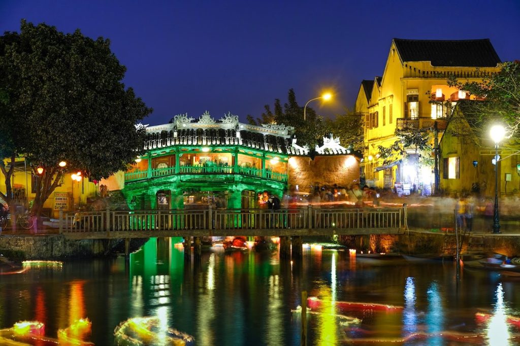 The Hoi An Japanese Bridge, also known as **Cau Pagoda**, is a historical and architectural treasure in **Hoi An Ancient Town**. Built in the early 17th century, it beautifully reflects a harmonious blend of Japanese, Chinese, and Vietnamese styles. Adorned with intricate wooden carvings and statues, this iconic landmark once connected two distinct cultural communities. It offers stunning photo opportunities, especially at sunrise and sunset, with its tranquil surroundings and vibrant lanterns illuminating the night, creating a timeless atmosphere for visitors.