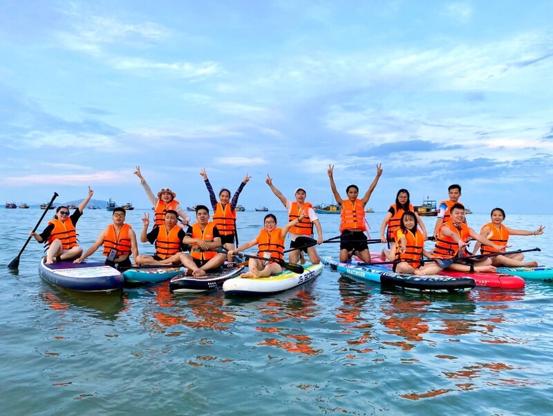 Friends pose and SUP in the sunshine.