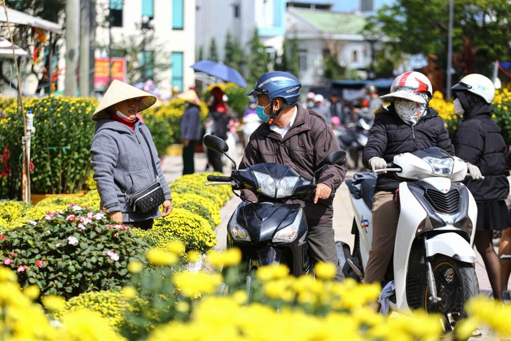 A group of motorcyclists celebrating Tet holiday, riding together in a festive atmosphere.